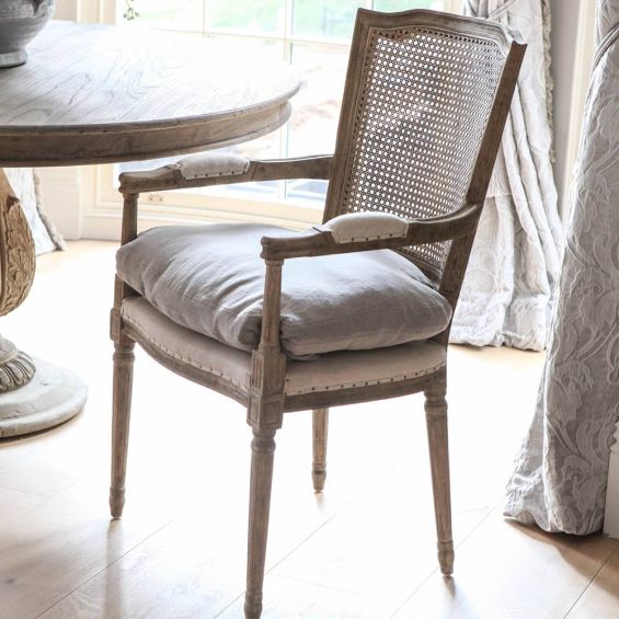 Stunning vintage style chair with rattan backrest, linen chair cushion and arms