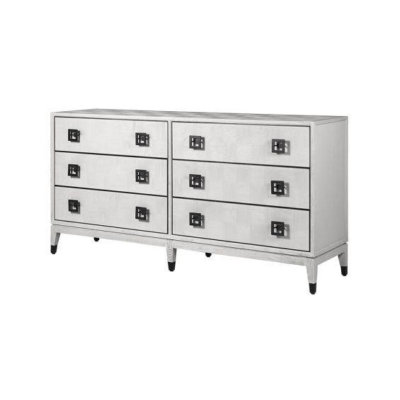 A luxurious six drawer chest of drawers with a white oak finish and bronze hardware