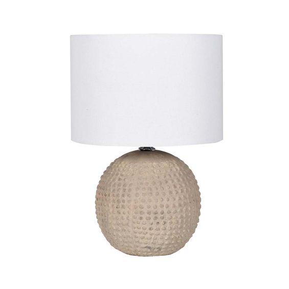 A gorgeous table lamp with a round, neutral and textured base with a white linen shade