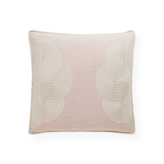 A chic cushion by Jonathan Adler made from linen with a blush colour and finished with 70s inspired patterns