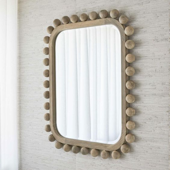 Natural-coloured wall mirror with wooden spheres on border