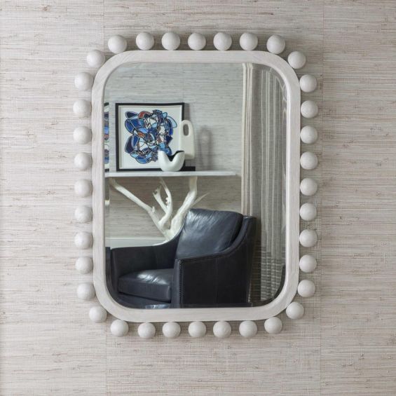 Wall mirror framed with white solid wooden spheres