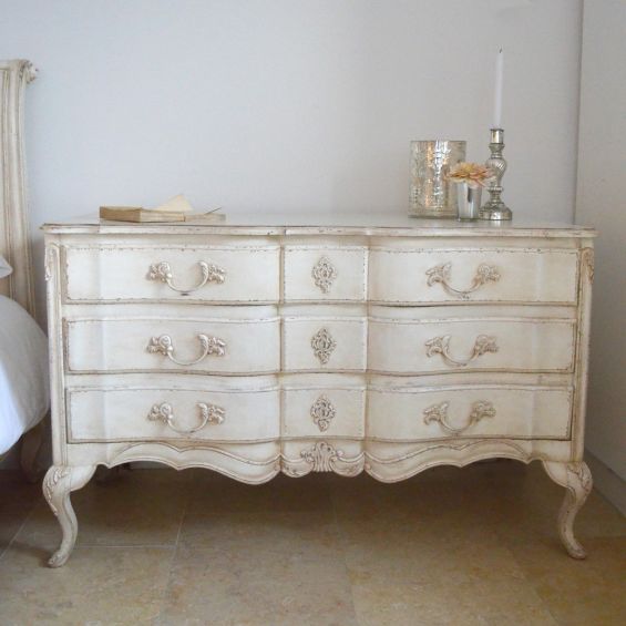 A french inspired chest of drawers with carved details.
