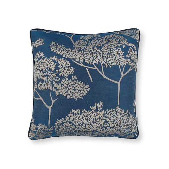 A dark blue square cushion with a contrasting beige coloured tree decoration