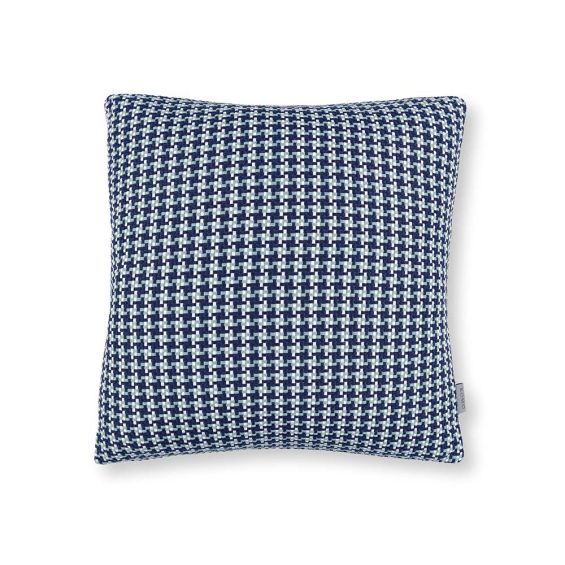 A blue houndstooth knitted outdoor cushion