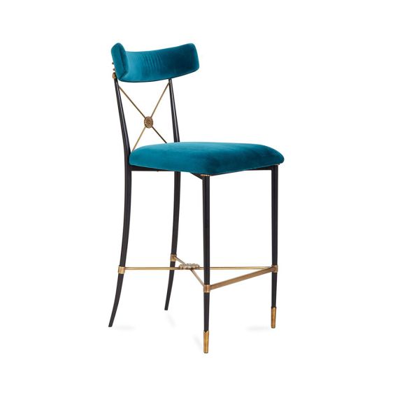A chic empire-style counter stool in blue velvet fabric 