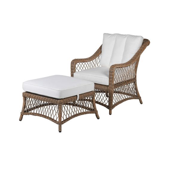 A beautiful outdoor garden set featuring a gorgeous rattan chair and footstool with soft white cotton cushions