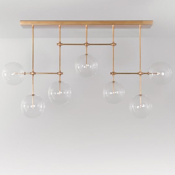 Natural brass industrial style chandelier with hanging clear glass globes