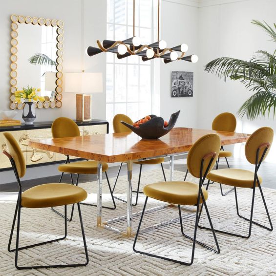 A rich yellow velvet dining chair with a blackened steel frame 