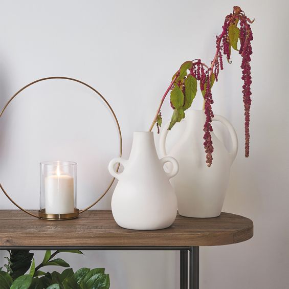 A gorgeous neutral vase with a curvy design and stylish handles 