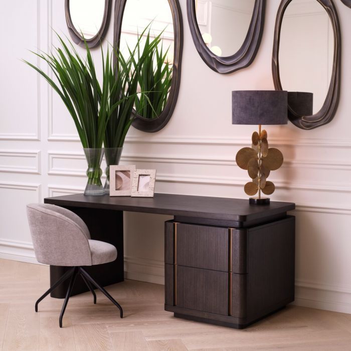 The Modesto Desk, crafted from mocha oak veneer with brushed brass accents, blends rustic charm and contemporary style, offering a spacious, elegant work surface.