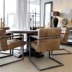 Round dining table with ornate base in dark brown