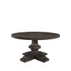 Round dining table with ornate base in dark brown