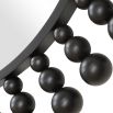 Elevate your decor with the Aziel Round Mirror—a stunning fusion of sleek satin black and modern sphere accents for a bold statement.