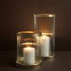 An elegant ribbed candle holder with an antique brass base and rim