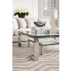 Contemporary glass coffee table with stainless steel frame and small shelf