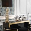 A glamorous table lamp with six crystal orbs, a polished gold finish and a lovely black shade