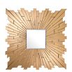 A bevelled square mirror with a starburst, brass frame