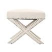 A delicate white velvet footstool adorned with nickel studs.