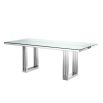 contemporary dining table with transparent surface and stainless steel frame