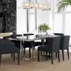 contemporary dining table with a transparent surface and stainless steel frame