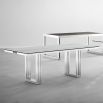 contemporary dining table with transparent surface and stainless steel frame