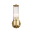 A glamorous wall lamp with an antiqued brass finish and reeded glass