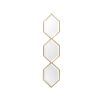 A glamorous wall mirror by Eichholtz with three hexagonal bevelled mirrors and a gold finish 