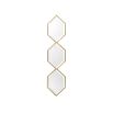 A glamorous wall mirror by Eichholtz with three hexagonal bevelled mirrors and a gold finish 