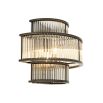 A glamorous, statement wall light from Eichholtz featuring clear glass rods and a bronze finish 