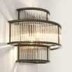A glamorous, statement wall light from Eichholtz featuring clear glass rods and a bronze finish 