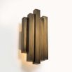 A vintage art deco inspired wall lamp with decorative alternating brass features