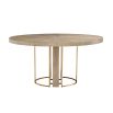 Light brown washed oak circular dining table with brass legs