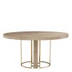 Light brown washed oak circular dining table with brass legs