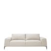 Designer contemporary shaped sofa with oversized arms and overfilled cushions on sharp legs upholstered in a natural fabric