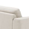 Designer contemporary shaped sofa with oversized arms and overfilled cushions on sharp legs upholstered in a natural fabric