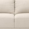 Designer contemporary shaped sofa with oversized arms and overfilled cushions on sharp legs upholstered in a natural fabric