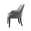 A beautiful grey velvet dining chair with black legs and antique brass studs