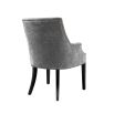 A beautiful grey velvet dining chair with black legs and antique brass studs