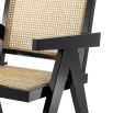 A stylish tropical dining chair with natural cane and black finish 