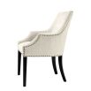 Luxury sand velvet dining chair with antique brass nail detailing and black legs
