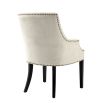 Luxury sand velvet dining chair with antique brass nail detailing and black legs
