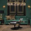 green velvet sofa with buttoning and brass accents 