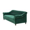 green velvet sofa with buttoning and brass accents 