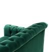 green velvet sofa with buttoning and brass accents 