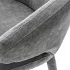 A sophisticated grey upholstered dining chair with tapered legs 