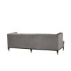 grey deep-buttoned sofa with velvet upholstery and black legs with gold accents