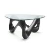 A statement coffee table by Eichholtz with a bold vintage brass base and clear glass top