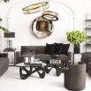 A statement coffee table by Eichholtz with a bold vintage brass base and clear glass top