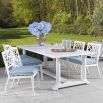 white outdoor dining chair with blue and white cushion lifestyle image